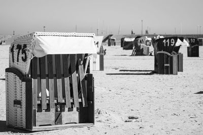 Clothes drying on wooden post at beach against clear sky