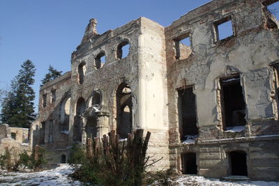 Low angle view of damaged building against clear sky