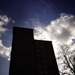 Low angle view of building against cloudy sky