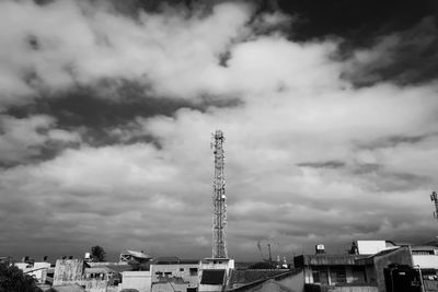 Low angle view of buildings against cloudy sky