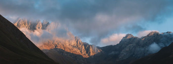 Fog and clouds rolling on the rocky peak