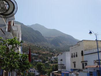 Buildings in town against clear sky