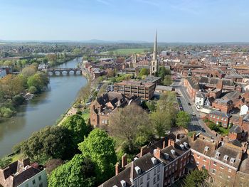 High angle view of river amidst buildings in city against sky