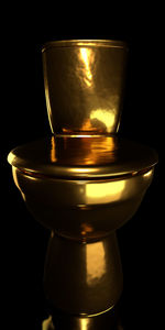 Close-up of wineglass on table against black background