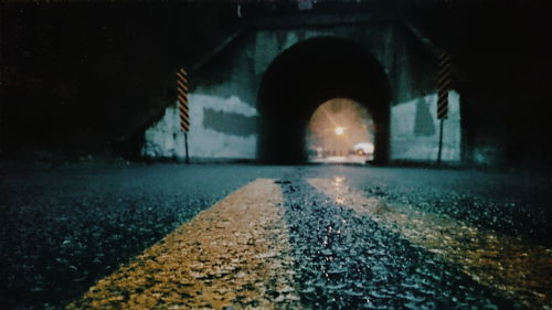 Illuminated tunnel at night