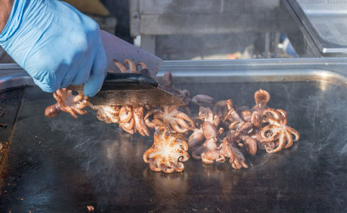 Man grilling sea food on barbecue grill