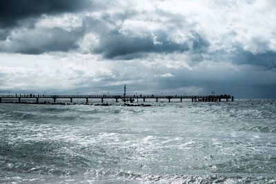 Pier over sea against sky