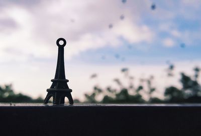 Silhouette of tower against cloudy sky