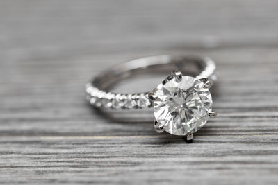 Close-up of diamond ring on table