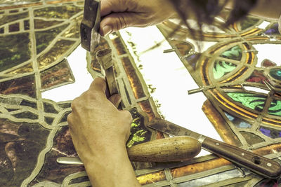 Low angle view of man working on metal