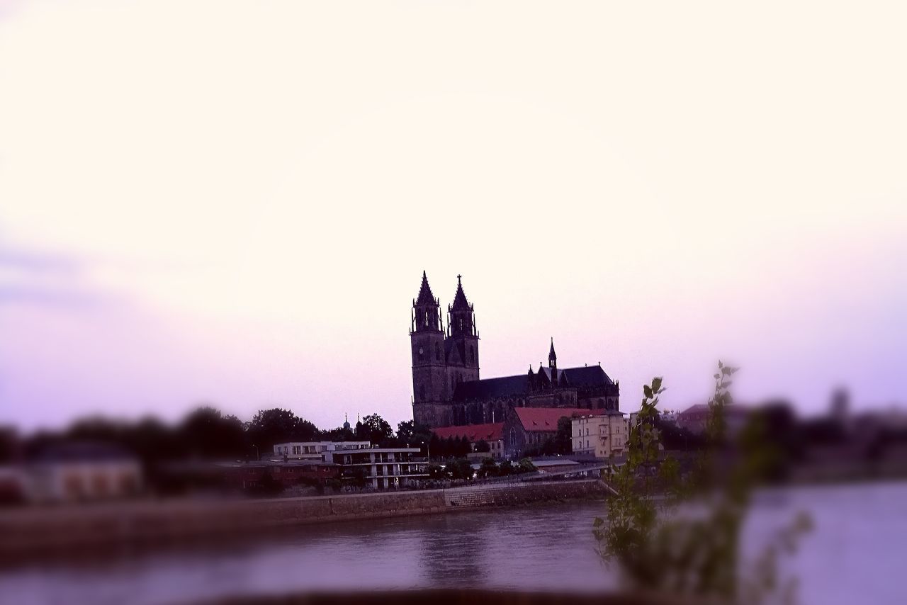 architecture, built structure, building exterior, water, travel destinations, dusk, famous place, tourism, waterfront, sky, river, surface level, the way forward, outdoors, history, day, footpath, spire, tall - high, no people, monument, moody sky