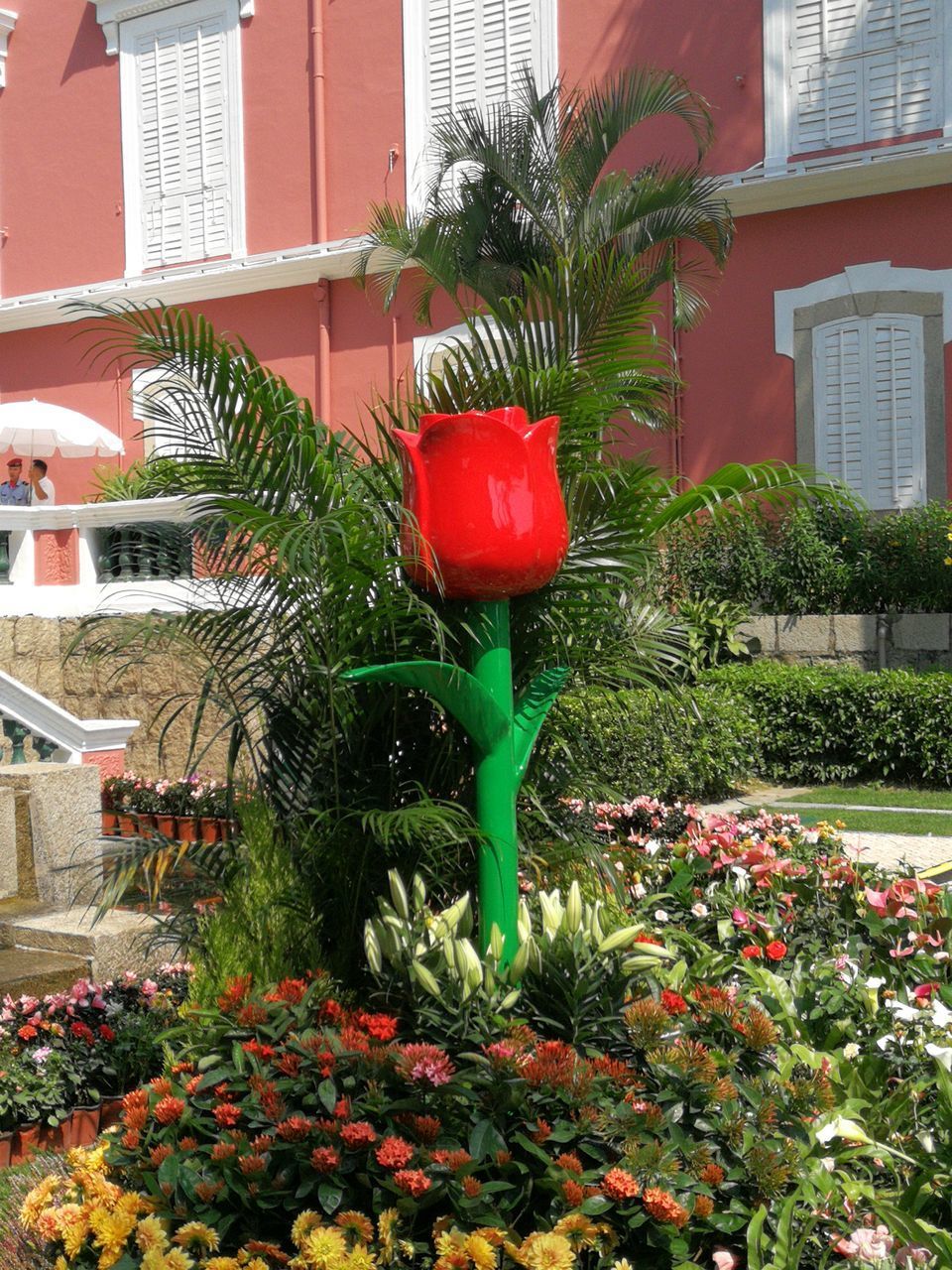 RED AND POTTED PLANT AGAINST BUILDING