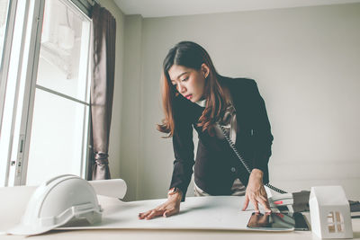 Young woman working on table