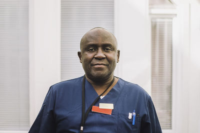 Portrait of mature male doctor with shaved head at hospital