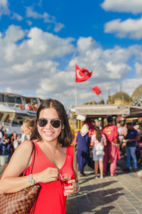 Young woman with sunglasses against blurred background