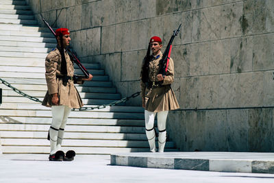 People on staircase against wall