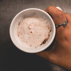 Close-up of hand holding coffee cup