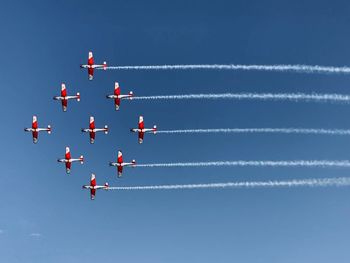 Low angle view of airshow against sky