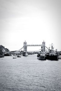 Boats on thames river against tower bridge