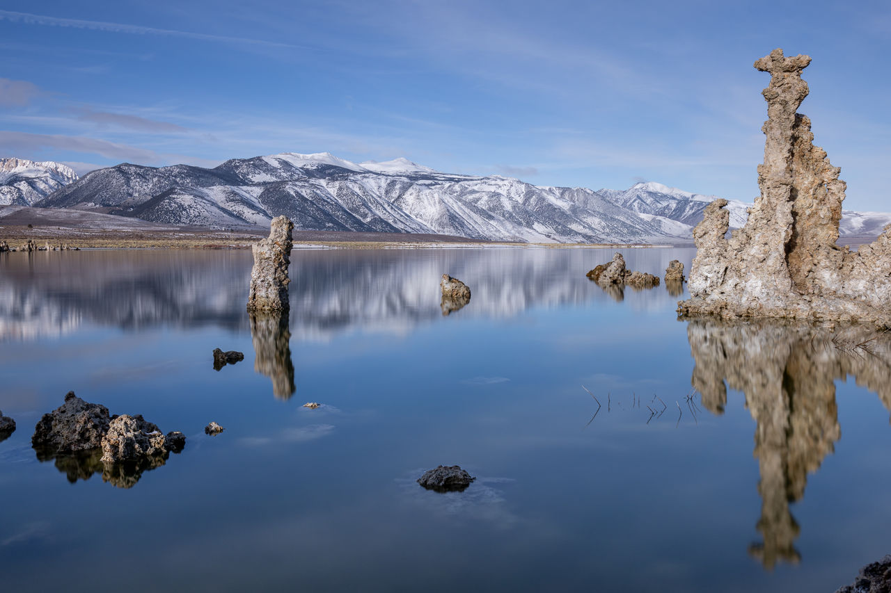 water, scenics - nature, sky, tranquil scene, beauty in nature, lake, tranquility, mountain, cloud - sky, waterfront, reflection, nature, non-urban scene, rock - object, solid, rock, idyllic, no people, day, snowcapped mountain