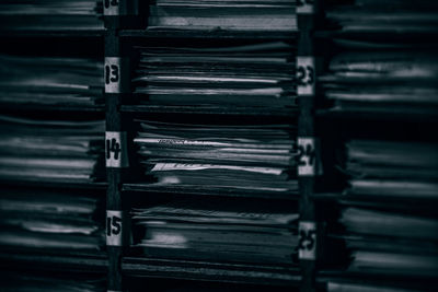 Full frame shot of papers in shelves with numbers