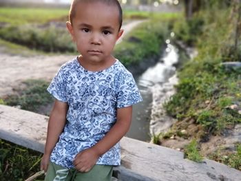 Portrait of cute boy standing outdoors