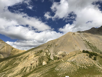 Scenic view of mountains against cloudy sky