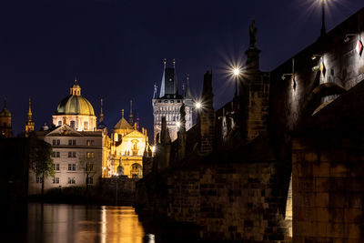 The vltava river flowing under the charles bridge in the heart of prague