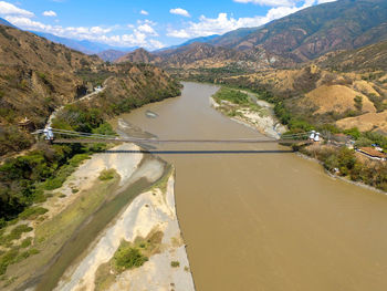 Scenic view of river amidst mountains against sky