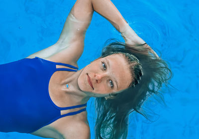 Portrait of young woman swimming in pool