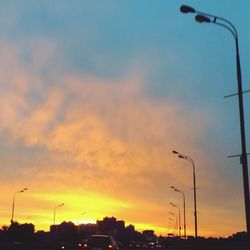 Cars on street at sunset