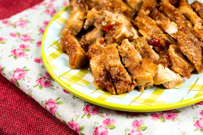 Close-up of chicken meat in plate on fabric