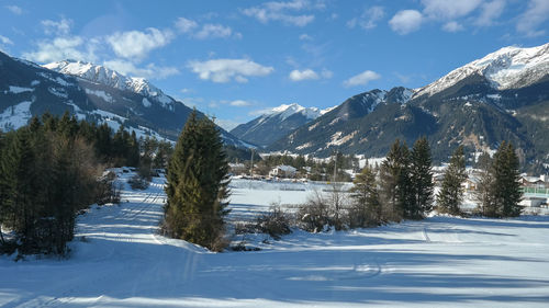 Snow covered landscape against sky