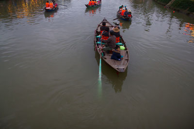 High angle view of people on boat sailing in river 