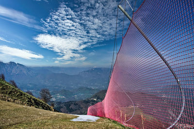 Ski slope in the mountains. on the side, red safety nets are installed