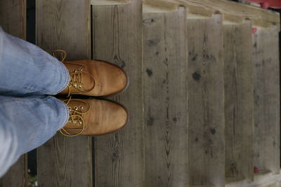 Low section of person standing on wooden floor