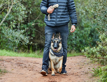 Portrait of man holding dog