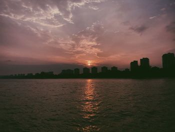 Scenic view of river against sky during sunset