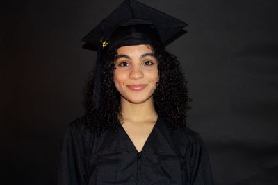 Portrait of woman wearing graduation gown