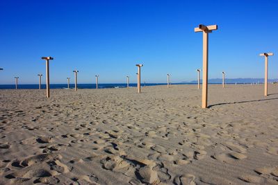 Scenic view of beach against clear blue sky