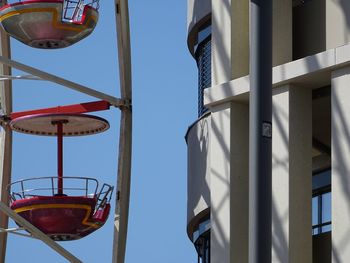 Low angle view of clothes hanging against clear blue sky