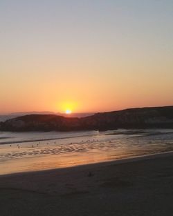 Scenic view of sea against clear sky during sunset