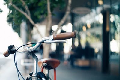 Close-up of bicycle parked on footpath