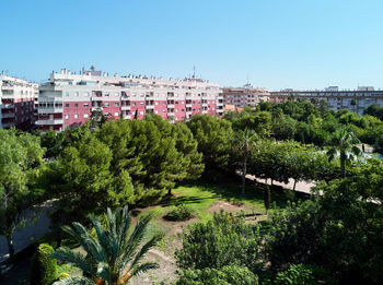 High angle view of trees and buildings against clear sky