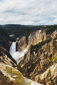 Scenic view of waterfall against sky