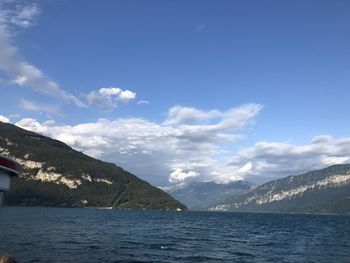 Scenic view of sea and mountains against sky