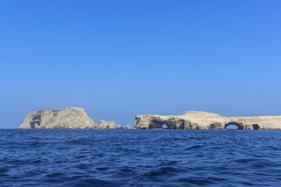 Scenic view of sea against clear blue sky