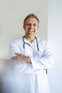Portrait of happy doctor with arms crossed