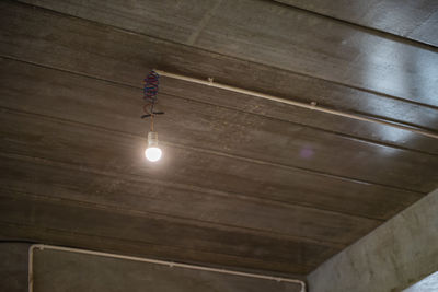 Low angle view of illuminated lights on ceiling