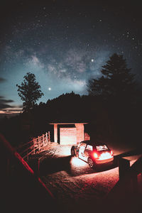 Illuminated car against sky at night